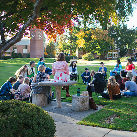 Student group meeting on campus quad