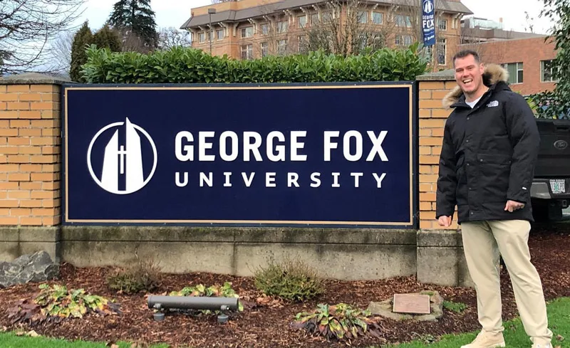 Martin in front of the George Fox sign