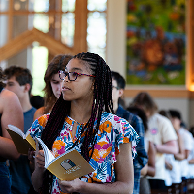 Student reading liturgy book