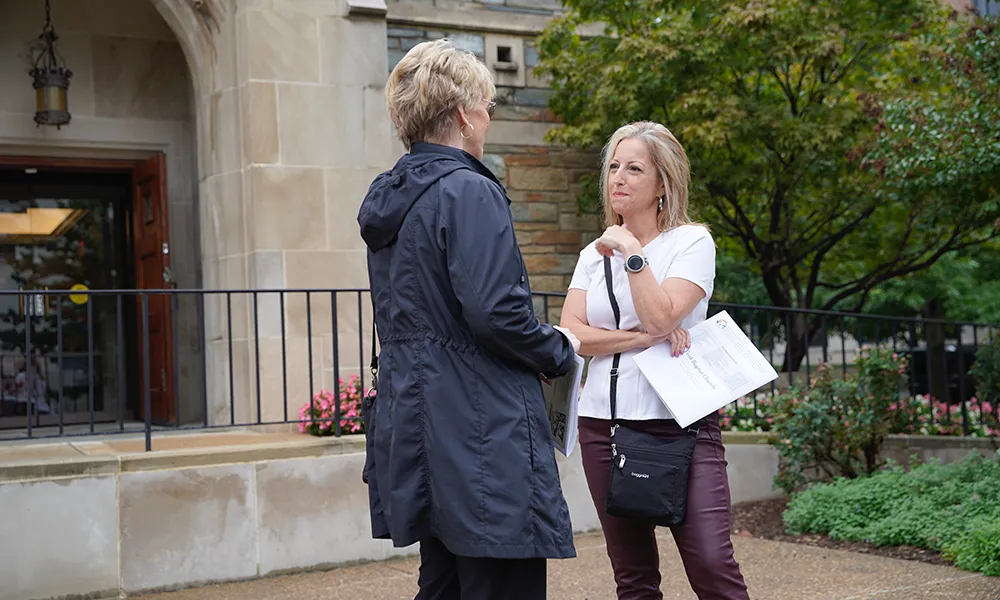 Jennifer having a discussion with someone outdoors