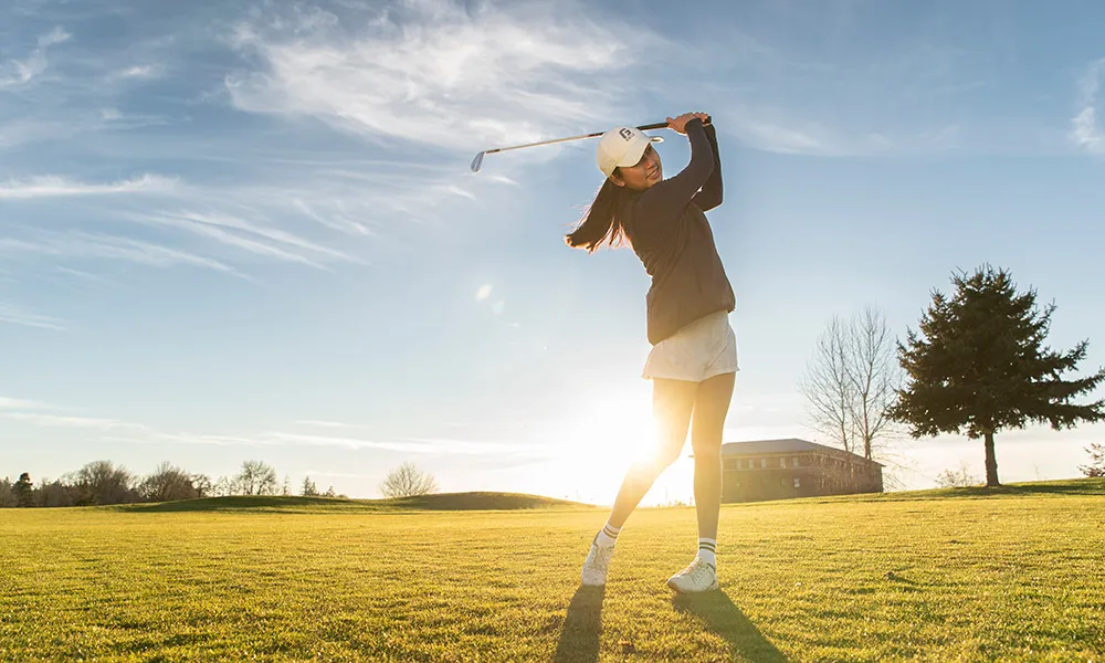 Alison takes a swing on the golf course