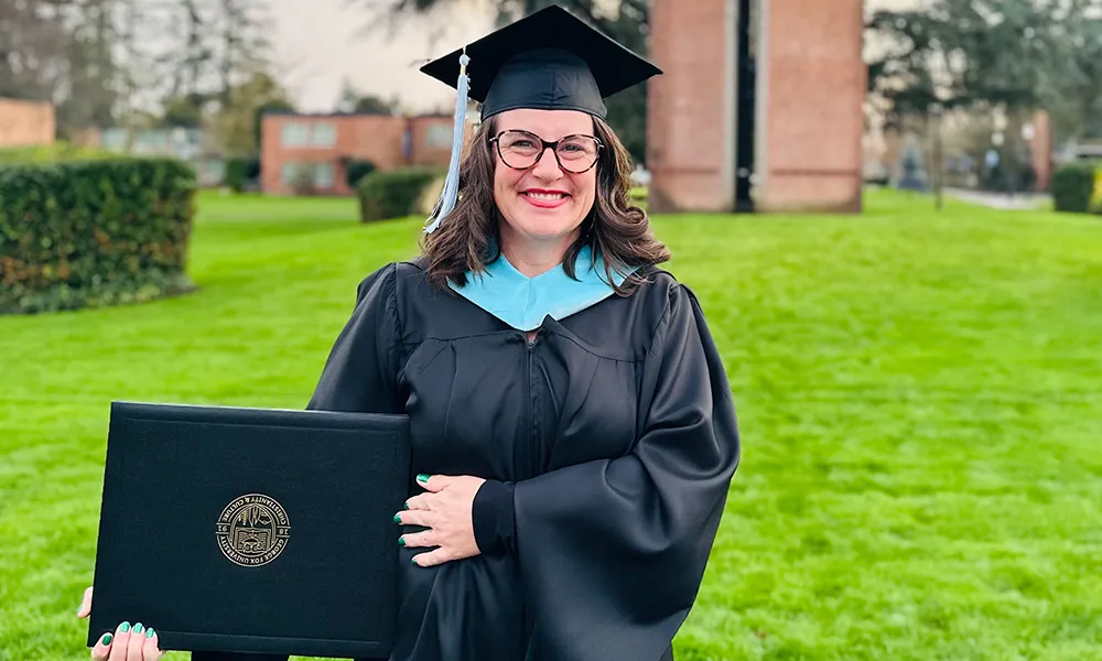 Sara Noelle Goodman holding her degree