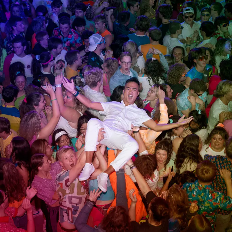 Student crowd surfs the 80s dance