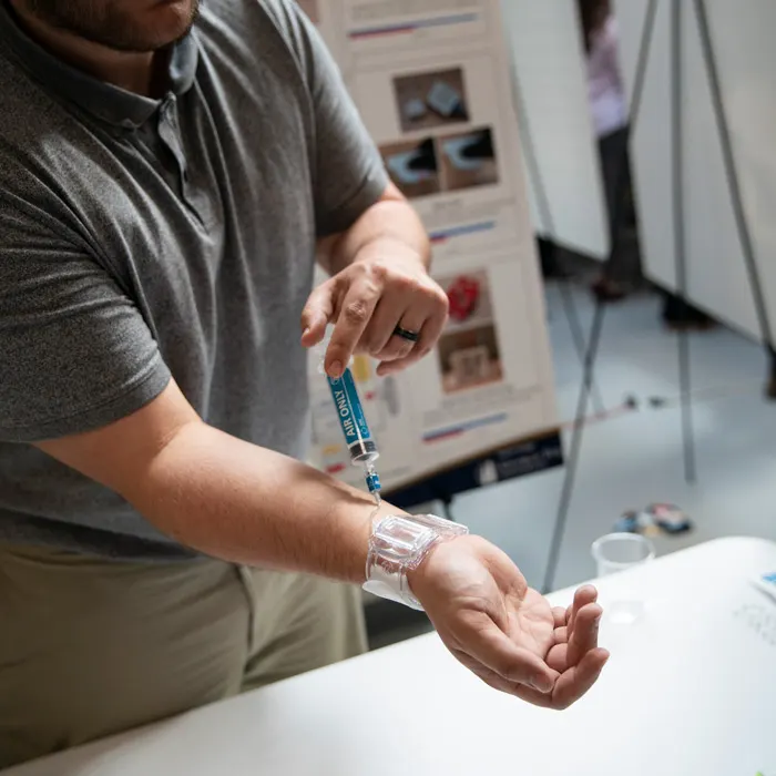 Biomedical device is demonstrated on a student's arm