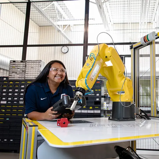 Student focuses on the 3d printer