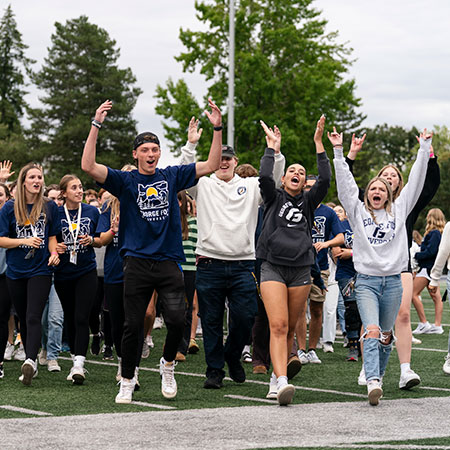 A group of new students cheering together