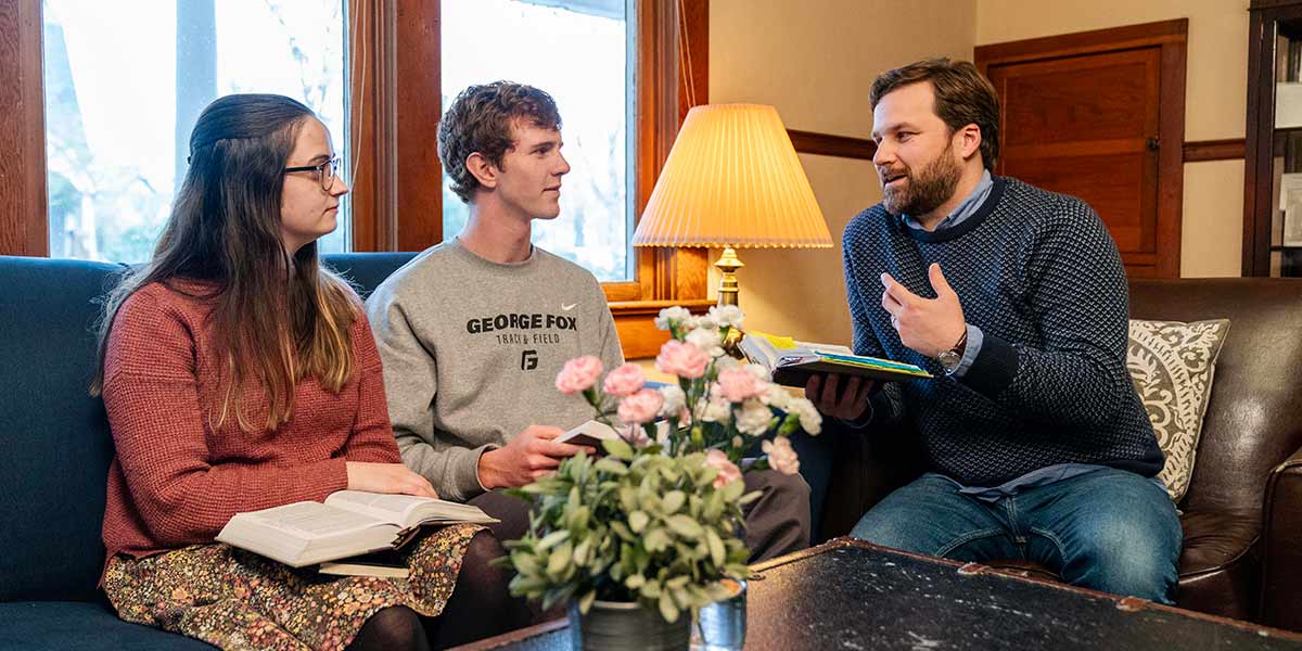 Honors students discussing the Bible with faculty members