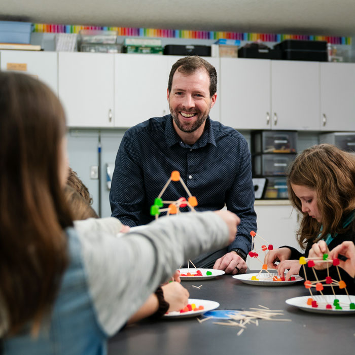 teacher calls on student raising their hand