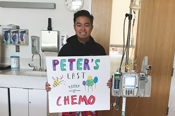 Peter holding a poster saying "Last Chemo"