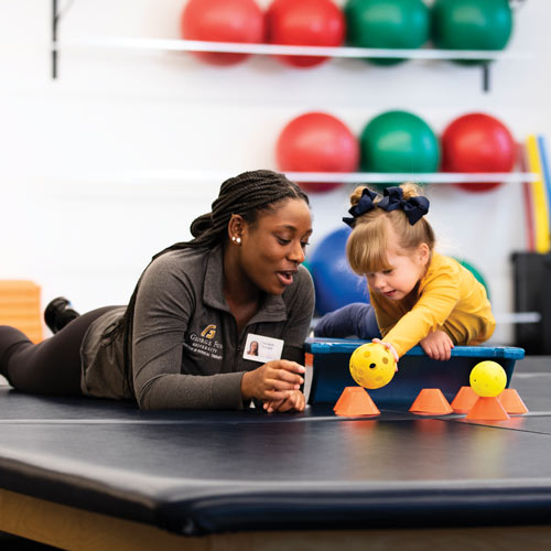Occupational therapy student with a child