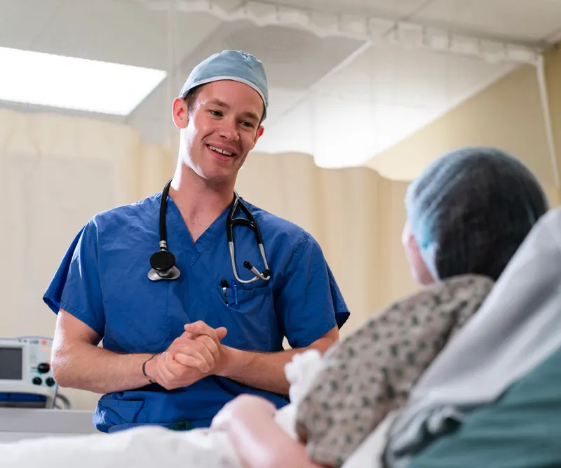 Student helps an older patient