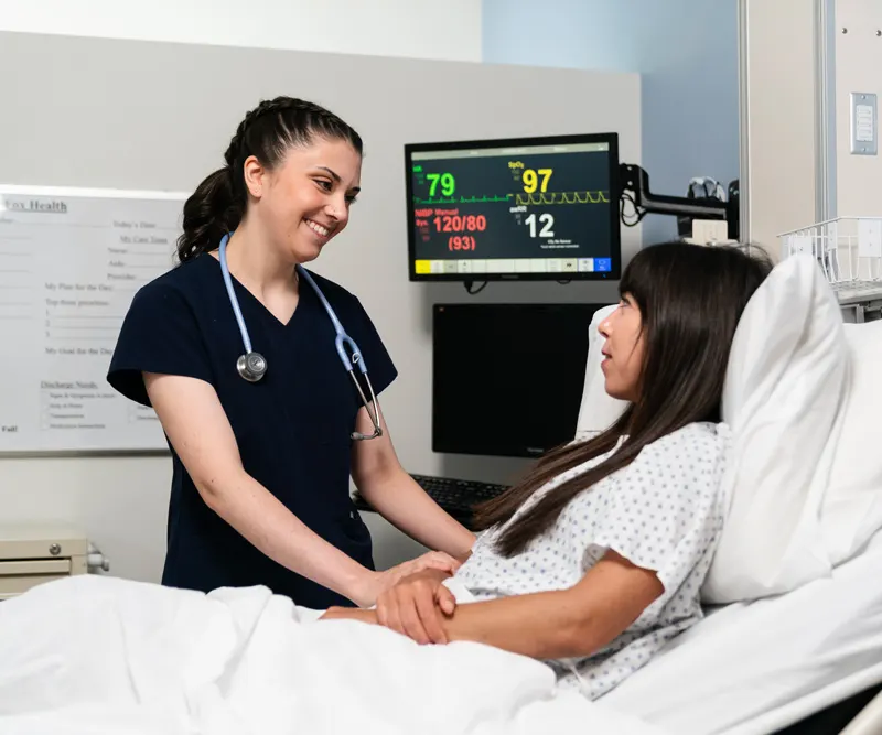 Student smiles with a patient