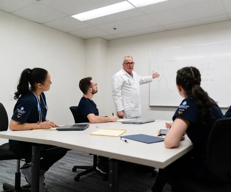 Professor with students during a presentation