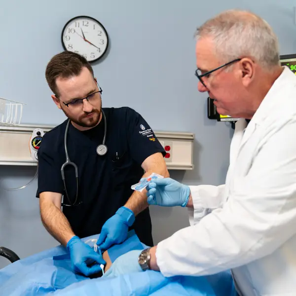 Bill Prosser showing a student something
