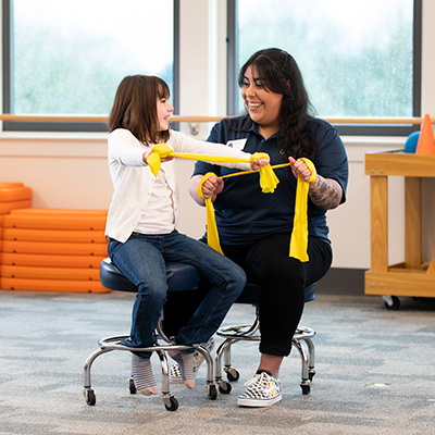 Student helping a child patient