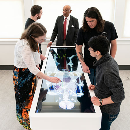 PA students studying around the Anatomage table