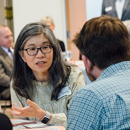 Professor Jeney Park-Hearn talking with a student at Portland Seminary